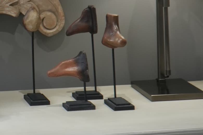 Four carved nose sculptures on stands at the practice